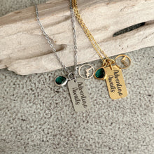 Load image into Gallery viewer, Adventure Awaits - Engraved stainless steel necklace - silver or gold with mountain charm and emerald green glass gem
