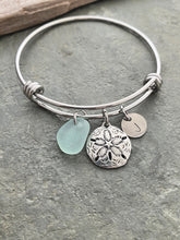 Load image into Gallery viewer, sand dollar charm bracelet, stainless steel adjustable bangle with genuine sea glass, and hand stamped initial disc Beach glass jewelry