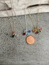 Load image into Gallery viewer, Three birthstone crystal necklaces rose gold, sterling silver and gold displayed with penny
