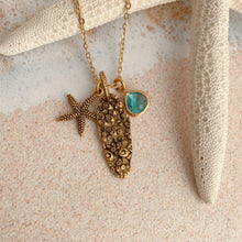 Load image into Gallery viewer, Gold beach charm necklace - starfish, barnacle shell charm and teal glass charm
