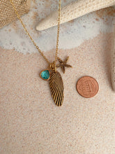 Load image into Gallery viewer, Gold beach charm necklace - starfish, barnacle shell charm and teal glass charm
