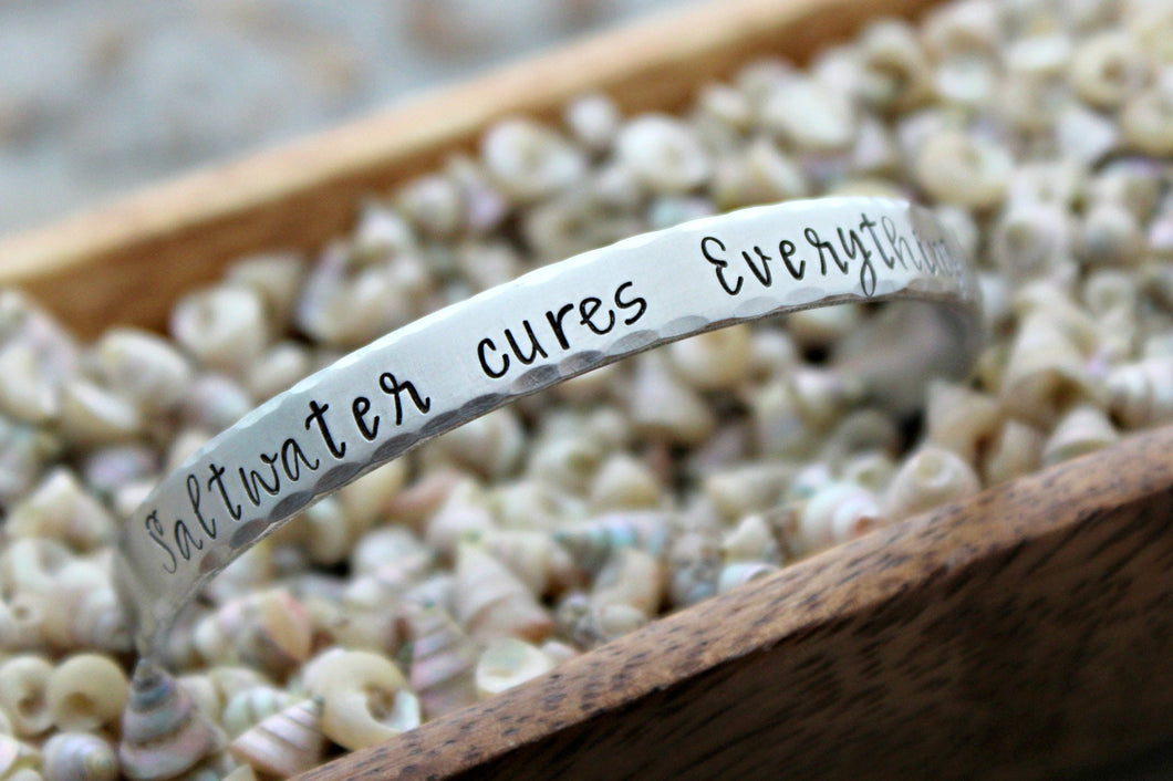 saltwater cures everything - Hand stamped bracelet - 1/4 Inch Bangle Silver tone aluminum - skinny Cuff Bracelet - gift for beach lover wave