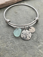 Load image into Gallery viewer, sand dollar charm bracelet, stainless steel adjustable bangle with genuine sea glass, and hand stamped initial disc Beach glass jewelry
