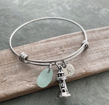 Load image into Gallery viewer, Lighthouse charm bracelet, stainless steel adjustable bangle with genuine sea glass, and hand stamped initial disc Beach glass jewelry
