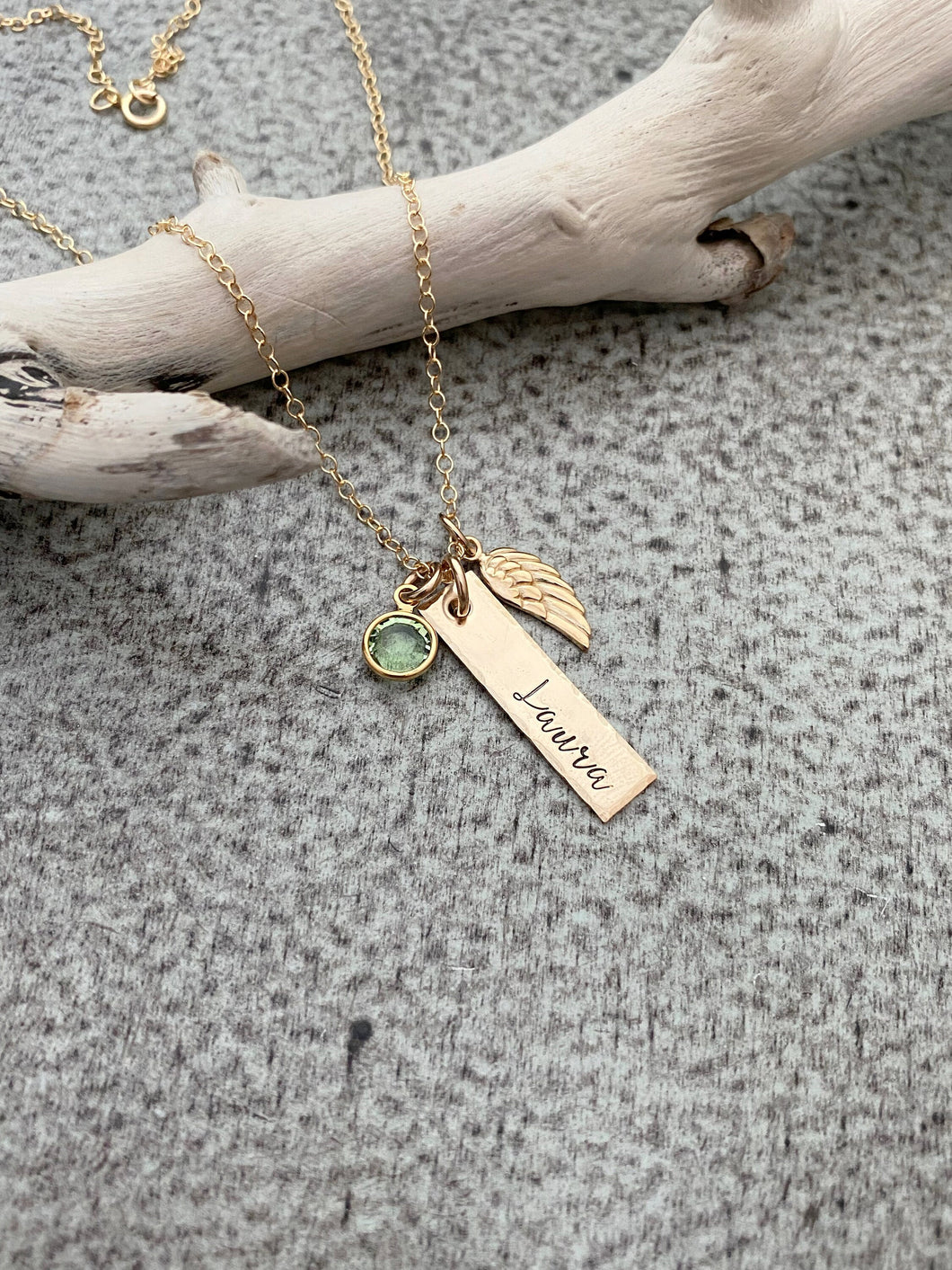 Gold tone necklace with birthstone crystal, bar with name and angel wing charm
