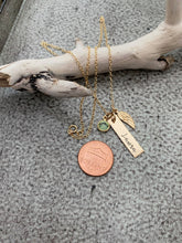 Load image into Gallery viewer, Gold tone necklace with birthstone crystal, bar with name and angel wing charm shown next to penny
