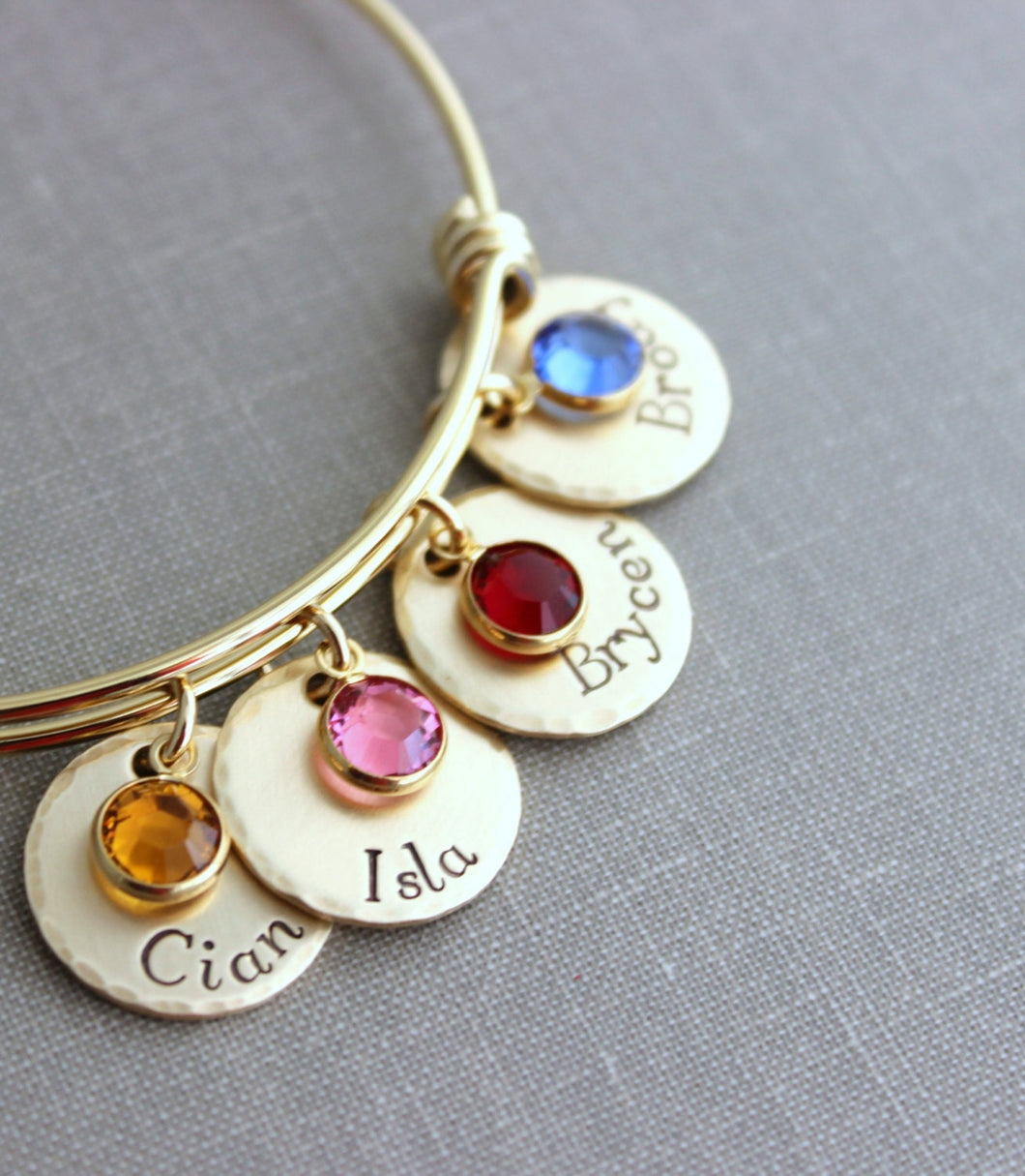 Gold plated stainless steel bracelet, Children's names Hand stamped NuGold discs, Swarovski crystal birthstones and wire bangle bracelet